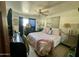 Calm bedroom featuring a cozy bed with soft pink accents, a side vanity, and a charming window with natural light at 8732 E Arlington Rd, Scottsdale, AZ 85250