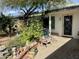 Inviting home entrance with decorative plants, a stone fountain feature, and a charming brick-paved walkway at 8732 E Arlington Rd, Scottsdale, AZ 85250