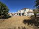 Expansive backyard with lawn area, in-ground pool, and covered patio with spiral staircase to balcony at 9043 E Posada Ave, Mesa, AZ 85212