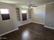 Bedroom with built in shelves, ceiling fan, and hardwood floors at 9043 E Posada Ave, Mesa, AZ 85212