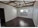 Bedroom features a decorative tray ceiling, ceiling fan, and wood-look floors at 9043 E Posada Ave, Mesa, AZ 85212