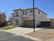 Charming two-story home with a well-kept lawn, desert landscaping, and convenient two-car garage at 9043 E Posada Ave, Mesa, AZ 85212