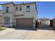 Two-story home with a spacious driveway and a two-car garage, perfect for Gathering living at 9043 E Posada Ave, Mesa, AZ 85212