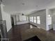 Bright and airy living room with a ceiling fan, built-in shelving, and hardwood floors at 9043 E Posada Ave, Mesa, AZ 85212