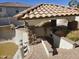 An outdoor kitchen area with a built-in grill and a brick patio at 9043 E Posada Ave, Mesa, AZ 85212