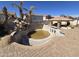 Large in-ground pool with a rock waterfall, slide, and a covered patio area at 9043 E Posada Ave, Mesa, AZ 85212