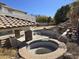 Large in-ground pool with a rock waterfall, slide, and a covered patio area near lawn at 9043 E Posada Ave, Mesa, AZ 85212