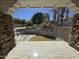 A vacant pool and a tiled pool deck on a sunny day at 9043 E Posada Ave, Mesa, AZ 85212