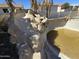 The in-ground pool has a built-in rock slide and waterfall feature. A beautiful backyard! at 9043 E Posada Ave, Mesa, AZ 85212