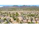 Expansive aerial view of the community surrounded by desert landscape and mountains in the distance at 9812 E Karen Dr, Scottsdale, AZ 85260