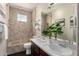 Contemporary bathroom featuring double sinks, modern tile, and glass shelves at 9812 E Karen Dr, Scottsdale, AZ 85260