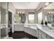 Bright bathroom featuring dual sinks and a tub with jet at 9812 E Karen Dr, Scottsdale, AZ 85260