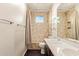 Bathroom with double sink vanity, tiled shower, and a window at 9812 E Karen Dr, Scottsdale, AZ 85260