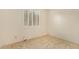 Neutral bedroom with large shuttered window and tile flooring at 9812 E Karen Dr, Scottsdale, AZ 85260