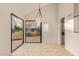 Bright dining area featuring tile flooring and a door leading to an outdoor patio at 9812 E Karen Dr, Scottsdale, AZ 85260