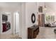 Open floorplan showcases a laundry room, entryway table and an open layout to the living room at 9812 E Karen Dr, Scottsdale, AZ 85260