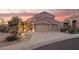 Exterior of the home, showing the desert landscaping and two car garage at 9812 E Karen Dr, Scottsdale, AZ 85260