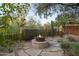 Charming backyard with stone firepit and desert landscaping, perfect for outdoor gatherings at 9812 E Karen Dr, Scottsdale, AZ 85260