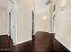 Upstairs hallway with dark wood floors and neutral walls, providing a bright and open feel at 9812 E Karen Dr, Scottsdale, AZ 85260