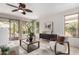 Comfortable living room featuring a ceiling fan and views of the backyard at 9812 E Karen Dr, Scottsdale, AZ 85260