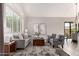 Bright living room with plantation shutters, neutral tones and a comfortable seating arrangement at 9812 E Karen Dr, Scottsdale, AZ 85260