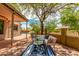 Inviting outdoor patio with a comfortable seating area under a shady tree at 9812 E Karen Dr, Scottsdale, AZ 85260