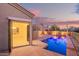 Backyard pool with a patio, illuminated pool, and an open back door at 9812 E Karen Dr, Scottsdale, AZ 85260