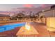 Relaxing backyard featuring a sparkling pool and a cozy fire pit, ideal for entertaining at 9812 E Karen Dr, Scottsdale, AZ 85260