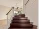 Elegant staircase with dark wood steps and white railings leading to the upper level at 9812 E Karen Dr, Scottsdale, AZ 85260