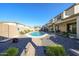 Inviting backyard featuring a sparkling pool, lush landscaping, and a charming patio area at 10322 W Edgemont Dr, Avondale, AZ 85392