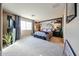 Nicely appointed bedroom with an accent wall mural, neutral carpet, and an ensuite bathroom at 10322 W Edgemont Dr, Avondale, AZ 85392