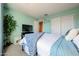 Bright bedroom with blue accents, a leafy green plant, and 'Live Laugh Love' wall art at 10322 W Edgemont Dr, Avondale, AZ 85392