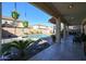 Charming covered patio space with views of the backyard pool, perfect for relaxation and entertainment at 10322 W Edgemont Dr, Avondale, AZ 85392