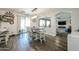 Bright dining area features wood floors, modern chandelier, and slider doors to the back yard at 10322 W Edgemont Dr, Avondale, AZ 85392