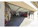 Spacious open garage featuring an orange car, tool storage, and automotive themed decorations at 10322 W Edgemont Dr, Avondale, AZ 85392