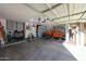Large garage with an orange truck, overhead lighting, and storage area at 10322 W Edgemont Dr, Avondale, AZ 85392