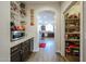View into a kitchen through an arched doorway; nearby is a pantry at 10322 W Edgemont Dr, Avondale, AZ 85392