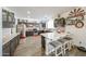 Spacious kitchen with modern appliances, dark cabinets, and bar stool seating at the island at 10322 W Edgemont Dr, Avondale, AZ 85392