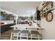 Wide angle view of the kitchen with bar stool seating, white countertops and stainless steel appliances at 10322 W Edgemont Dr, Avondale, AZ 85392