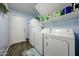 Laundry room with washer, dryer, and refrigerator, plus storage shelves and blue accents at 10322 W Edgemont Dr, Avondale, AZ 85392