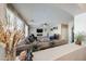 Spacious living room showcasing neutral tones, plush seating, large windows and an electric fireplace at 10322 W Edgemont Dr, Avondale, AZ 85392
