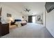Spacious main bedroom with a ceiling fan, TV, neutral carpet, and a sliding glass door to the backyard at 10322 W Edgemont Dr, Avondale, AZ 85392