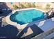 Overhead view of a blue swimming pool, complete with playful features and pebble landscaping at 10322 W Edgemont Dr, Avondale, AZ 85392