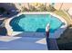 Outdoor swimming pool featuring playful backyard decor, an umbrella, and landscaping at 10322 W Edgemont Dr, Avondale, AZ 85392
