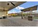 Beautiful backyard with a covered patio, built-in BBQ island, seating area, and well-maintained lawn at 10719 E Simone Ave, Mesa, AZ 85212
