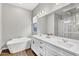 Elegant bathroom with a soaking tub, double vanity, and modern fixtures at 10719 E Simone Ave, Mesa, AZ 85212