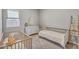 Bright bedroom with two cribs, dresser, carpeted floors, and window with blinds at 10719 E Simone Ave, Mesa, AZ 85212