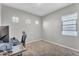 Bright bedroom featuring neutral walls, carpet, and a computer desk with a window at 10719 E Simone Ave, Mesa, AZ 85212
