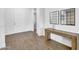 Modern entryway featuring wood floors, a wooden console table, and decorative mirrors at 10719 E Simone Ave, Mesa, AZ 85212