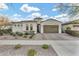 Charming single-story home featuring desert landscaping, a two-car garage, and a barrel-tile roof on a sunny day at 10719 E Simone Ave, Mesa, AZ 85212